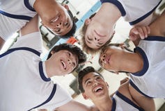Low Angle View Of Male High School Basketball Players Having Team Talk stock photo Low Angle View Of Male High School Basketball Players Having Team Talk stock photo