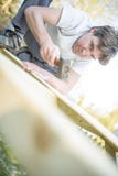 Low angle view of young man using a hammer or mallet to nail a n royalty free stock image Low angle view of young man using a hammer or mallet to nail a n royalty free stock image