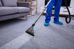 Male Janitor Cleaning Carpet