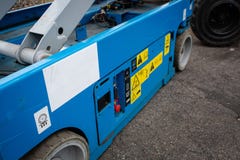 Lower part of scissor lift. Various buttons for operating machine. stock photography Lower part of scissor lift. Various buttons for operating machine. stock photography