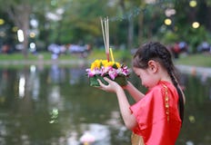 Loy Krathong festival, Asian Child girl in Thai traditional dress with holding krathong for forgiveness Goddess Ganges to royalty free stock photography Loy Krathong festival, Asian Child girl in Thai traditional dress with holding krathong for forgiveness Goddess Ganges to royalty free stock photography