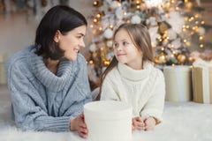 Ludzi, rodziny, świętowania i wakacji pojęcie, Matka i córka z atrakcyjnego pojawienia spojrzeniem przy each s ` innymi oczami, k zdjęcie stock Ludzi, rodziny, świętowania i wakacji pojęcie, Matka i córka z atrakcyjnego pojawienia spojrzeniem przy each s ` innymi oczami, k zdjęcie stock