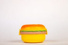 Lunchbox in the form of a yellow hamburger for preserving and carrying homemade food or sandwiches during working day. The symbol royalty free stock image Lunchbox in the form of a yellow hamburger for preserving and carrying homemade food or sandwiches during working day. The symbol royalty free stock image