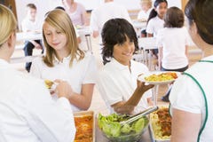 Lunchladies serving plates of lunch in a school royalty free stock image Lunchladies serving plates of lunch in a school royalty free stock image