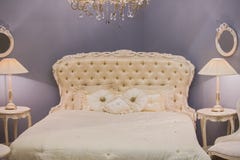 Luxurious expensive interior design of the children`s girl room in the old style. White bed, silk pillows, bedside tables with ta stock images Luxurious expensive interior design of the children`s girl room in the old style. White bed, silk pillows, bedside tables with ta stock images