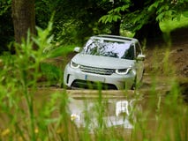 Luxury SUV 4x4 off-roading through a pond. royalty free stock photo Luxury SUV 4x4 off-roading through a pond. royalty free stock photo