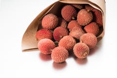Lychee in paper bag on white background stock images Lychee in paper bag on white background stock images