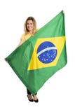Lycklig kvinnlig fan med den brasilianska flaggan som rymmer en fotbollboll royaltyfri bild Lycklig kvinnlig fan med den brasilianska flaggan som rymmer en fotbollboll royaltyfri bild