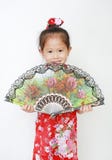 Lycklig liten asiatisk barnflicka som rymmer fanen för kinesisk stil på vit bakgrund under kinesisk festival för nytt år royaltyfri bild Lycklig liten asiatisk barnflicka som rymmer fanen för kinesisk stil på vit bakgrund under kinesisk festival för nytt år royaltyfri bild