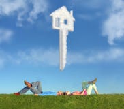 Lying couple on grass and dream house key collage