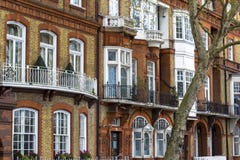 Lyxigt tegelstenhus med vita f?nster i tyst omr?de i centrala London L?genheter p? bankerna av Themsen royaltyfri fotografi Lyxigt tegelstenhus med vita f?nster i tyst omr?de i centrala London L?genheter p? bankerna av Themsen royaltyfri fotografi