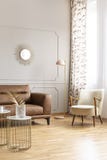 Lámpara colocada en la esquina del interior brillante del salón con el espejo decorativo en la pared con el moldeado, ventana con fotografía de archivo Lámpara colocada en la esquina del interior brillante del salón con el espejo decorativo en la pared con el moldeado, ventana con fotografía de archivo
