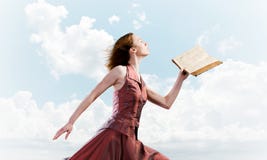 M?dchen gegen bew?lkten Himmel mit ge?ffnetem Buch in der Palme als Idee f?r Wissen lizenzfreie stockfotografie M?dchen gegen bew?lkten Himmel mit ge?ffnetem Buch in der Palme als Idee f?r Wissen lizenzfreie stockfotografie
