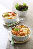 Macaroni and cheese with tomato. Macaroni and cheese served in two ramekin with cherry tomato, and green salad aside Macaroni and cheese with tomato. Macaroni and cheese served in two ramekin with cherry tomato, and green salad aside