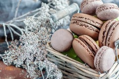 Macarons sensibles de meringue d'amande dans un panier en osier sur la table Plan rapproché image stock Macarons sensibles de meringue d'amande dans un panier en osier sur la table Plan rapproché image stock