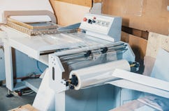 Machine for packing products with plastic wrap