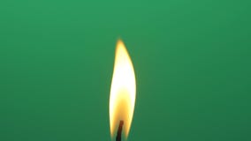 Macro abstract candle flame light isolated on green screen chroma key background