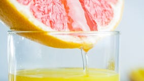 Macro image of grapefruit fresh juice flowing from freshly cut slice in glass stock images Macro image of grapefruit fresh juice flowing from freshly cut slice in glass stock images