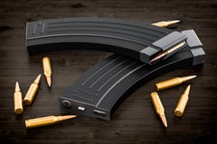 Magazine from assault rifle and bullets on the wooden table, 3D vector illustration Magazine from assault rifle and bullets on the wooden table, 3D vector illustration