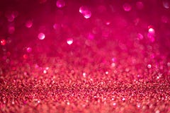 Magenta shiny glitter texture. Selective focus. Glowing surface, sparkle lights and bokeh effects. Christmas and festive