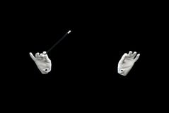 Magician hands with magic wand showing trick stock photos Magician hands with magic wand showing trick stock photos