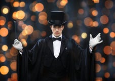 Magician in top hat showing trick with magic wand Stock Images Magician in top hat showing trick with magic wand Stock Images
