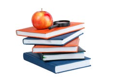 Magnifying Glass And Red Apple On Stack Of Books Royalty Free Stock Photos
