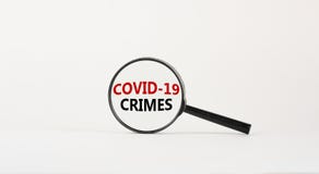 Magnifying glass with words `covid-19 crimes` on beautiful white background. Business concept, copy space