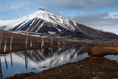 Majesctic Pyramida mountain that towers over the abandoned Russian ghost town Pyramiden in Svalbard stock photos Majesctic Pyramida mountain that towers over the abandoned Russian ghost town Pyramiden in Svalbard stock photos