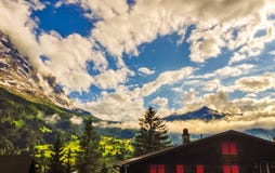 Majestic Panoramic view of Grindelwald Landscape and Cloudscape with golden light reflected, Canton of Berne, Switzerland royalty free stock photography Majestic Panoramic view of Grindelwald Landscape and Cloudscape with golden light reflected, Canton of Berne, Switzerland royalty free stock photography