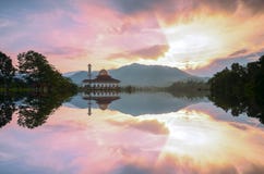 Majestic view of Darul Quran Mosque during sunset with mirror reflection in the lake stock photography Majestic view of Darul Quran Mosque during sunset with mirror reflection in the lake stock photography