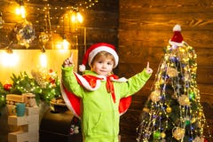 Make wish. Best wishes for you your family this christmas. Merry christmas and happy new year. Cute boy play near royalty free stock photography Make wish. Best wishes for you your family this christmas. Merry christmas and happy new year. Cute boy play near royalty free stock photography