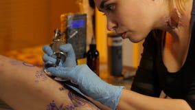 Makes a beautiful tattoo in the studio stock video Makes a beautiful tattoo in the studio stock video