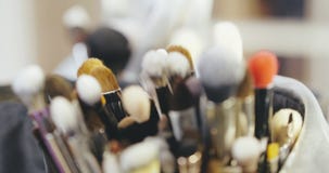 Makeup Artist Brushes Behind the Scenes of Fashion Show stock video footage Makeup Artist Brushes Behind the Scenes of Fashion Show stock video footage