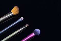 Makeup brushes on black background. Cosmetics, fashion, beauty, glamour. Accessories for make-up artist stock images Makeup brushes on black background. Cosmetics, fashion, beauty, glamour. Accessories for make-up artist stock images