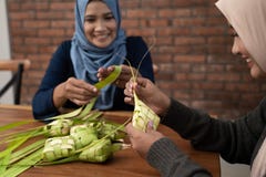 Making ketupat traditional indonesian food together stock images Making ketupat traditional indonesian food together stock images