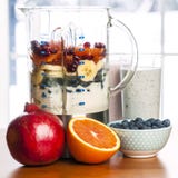 Making smoothies in blender with fruit and yogurt stock image Making smoothies in blender with fruit and yogurt stock image