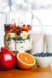 Making smoothies in blender with fruit and yogurt royalty free stock photo Making smoothies in blender with fruit and yogurt royalty free stock photo