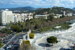 Beautiful view of the historical part of the city of Malaga with a review wheel. Castle, streets, harbor, cars stock image Beautiful view of the historical part of the city of Malaga with a review wheel. Castle, streets, harbor, cars stock image
