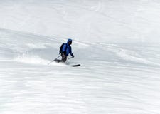 Male backcountry skier telemark skiing in the Alps in fresh powder Royalty Free Stock Images Male backcountry skier telemark skiing in the Alps in fresh powder Royalty Free Stock Images