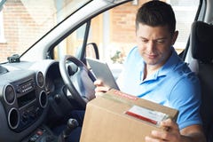 Male Courier In Van With Digital Tablet Delivering Package To House royalty free stock image Male Courier In Van With Digital Tablet Delivering Package To House royalty free stock image