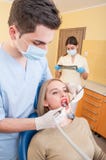 Male dentist doctor, female patient and woman assistant royalty free stock photo Male dentist doctor, female patient and woman assistant royalty free stock photo