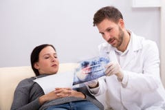 Male Doctor Explaining X-ray To Patient royalty free stock photo Male Doctor Explaining X-ray To Patient royalty free stock photo