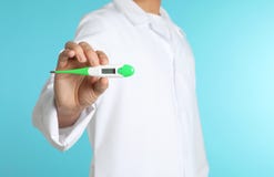 Male doctor holding digital thermometer on color background, closeup. royalty free stock photography Male doctor holding digital thermometer on color background, closeup. royalty free stock photography