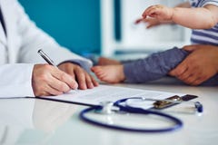 Male doctor with mother and her child Stock Images Male doctor with mother and her child Stock Images