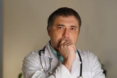 Portrait of male doctor with hand on chin royalty free stock photos Portrait of male doctor with hand on chin royalty free stock photos