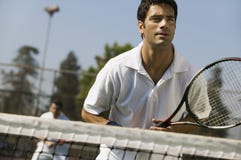Male doubles tennis players waiting for serve front view focus on foreground stock images Male doubles tennis players waiting for serve front view focus on foreground stock images