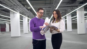 Male and female architects are talking about a project stock footage Male and female architects are talking about a project stock footage