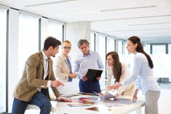 Male and female design professionals having discussion at table in new office Royalty Free Stock Photo Male and female design professionals having discussion at table in new office Royalty Free Stock Photo