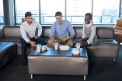 Male and female executives having snacks stock photos Male and female executives having snacks stock photos